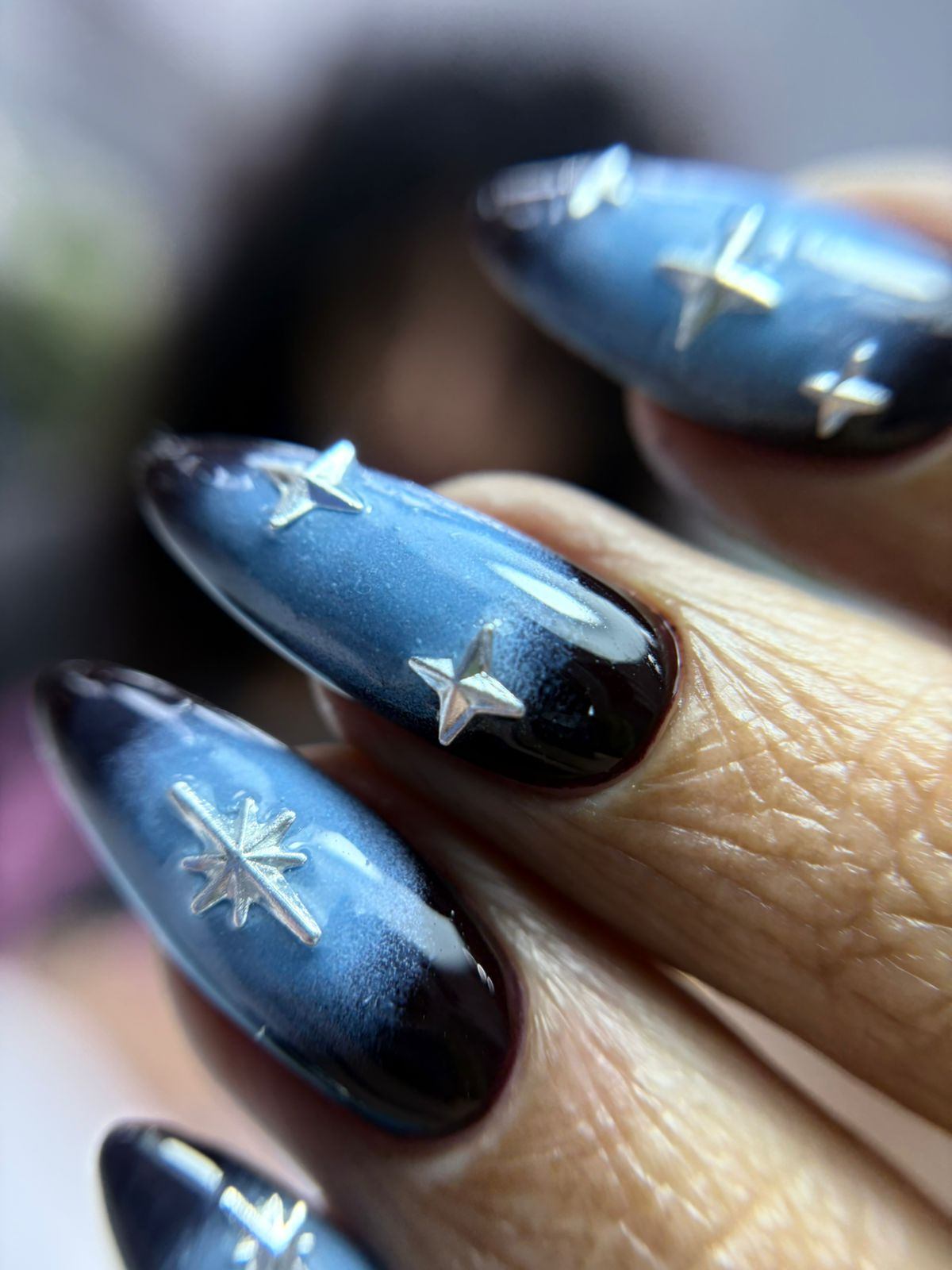Midnight blue cat-eye nails with silver star charms